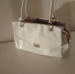 White leather designer handbag. Gold clasp.